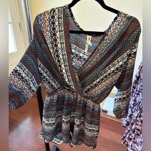 Long sleeve romper. Geometric pattern. Flowy and flattering.